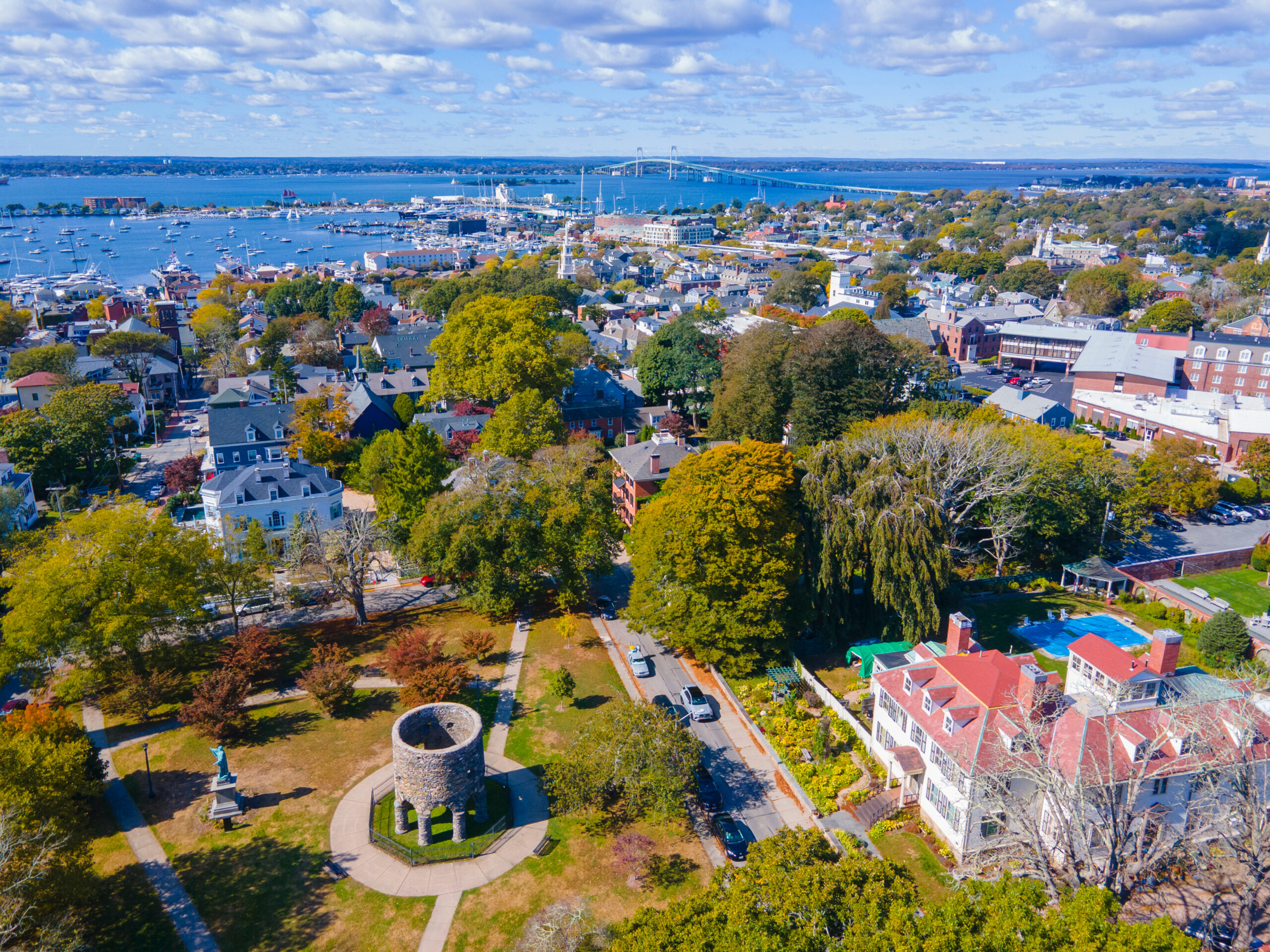 Touro Park aerial view including Windmill Tower with Newport Harbor at the background, city center of Newport, Rhode Island RI, USA. Paul Chapman - Newport County Realtor